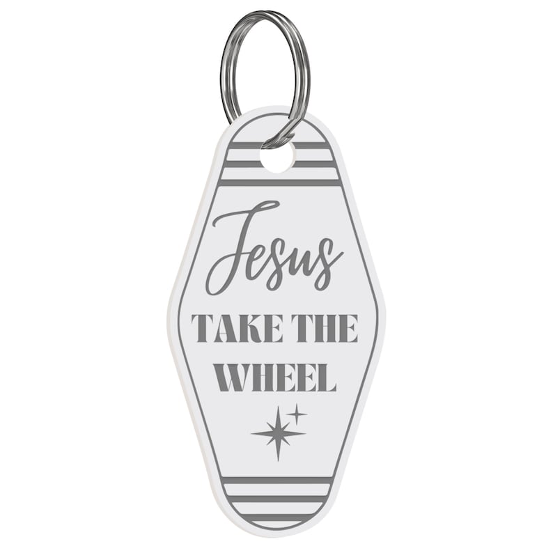 May include: White motel key chain with the text "Jesus Take the Wheel" in gray lettering and a gray star design.
