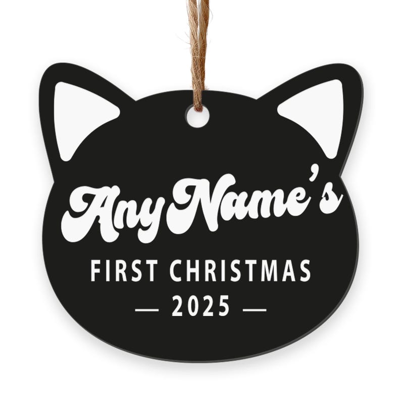 May include: Black cat-shaped Christmas ornament with white accents and a jute string for hanging. The ornament features the text "Any Name's FIRST CHRISTMAS - 2025 -" in white, making it a personalized holiday decoration.