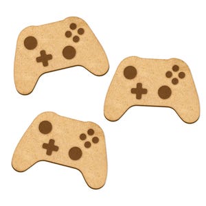 May include: Three wooden game controller cutouts, each with a brown outline of the buttons and a plus sign. The controllers are light brown and have a rough texture.