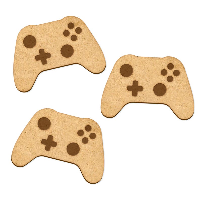 May include: Three wooden game controller cutouts, each with a brown outline of the buttons and a plus sign. The controllers are light brown and have a rough texture.
