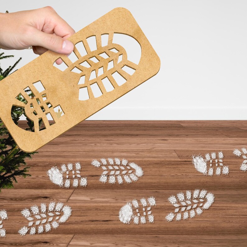 May include: A wooden cutout of a boot print is held above a wooden floor with several white footprints on it. The footprints are arranged in a line, with the boot cutout positioned above the first footprint.