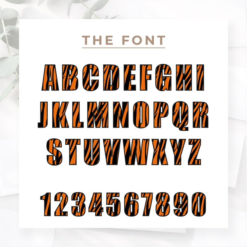 May include: A complete alphabet and number set in a bold, tiger stripe design. The letters and numbers are orange with black stripes, set against a white background. The text "THE FONT" is above the alphabet.