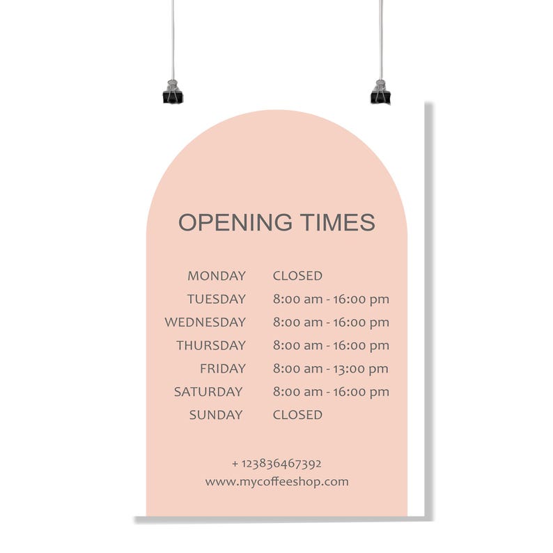 May include: A poster with the text "OPENING TIMES" in a coffee shop. The poster has a peach-colored arch shape with the shop's hours listed for each day of the week, including the phone number and website.