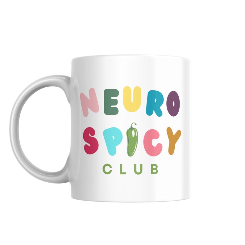 May include: White ceramic mug with a colorful graphic that says "NEURO SPICY CLUB" with a green chili pepper in the middle of the word "SPICY".