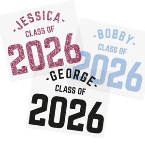 May include: Three white square stickers with graduation-themed text. The stickers feature names like "Jessica," "Bobby," and "George," along with "Class of 2026." The "2026" is in glittery pink, light blue, and black.