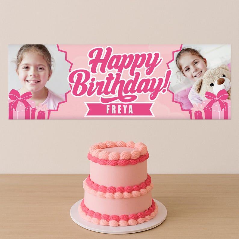 May include: A pink birthday banner with the text "Happy Birthday!" and the name "Freya". The banner has photos of a girl and gift boxes. A two-tiered pink cake with decorative frosting sits below.