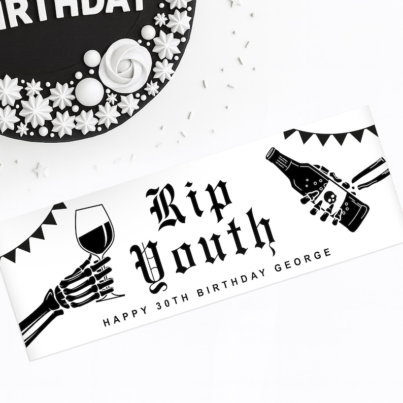 May include: A black and white banner with the text "Rip Youth" in gothic font, flanked by skeleton hands holding a wine glass and a bottle with a skull. The banner reads "Happy 30th Birthday George". A black cake with white decorations is in the background.
