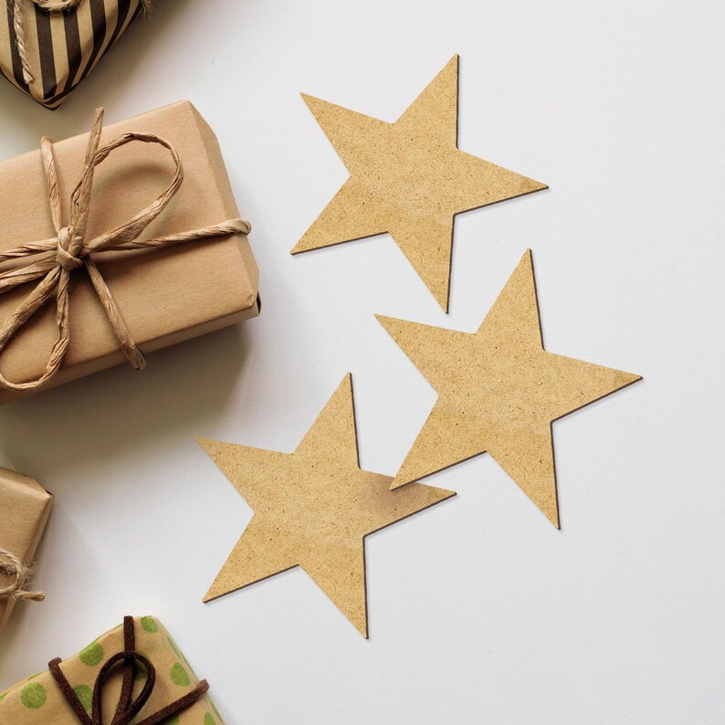 May include: Three brown cardboard stars on a white background. The stars are arranged in a staggered pattern, with the largest star at the top and the smallest star at the bottom.