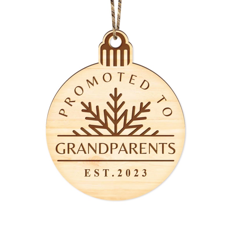 May include: A wooden Christmas ornament shaped like a circle with the text "Promoted to Grandparents Est. 2023" and a snowflake design.