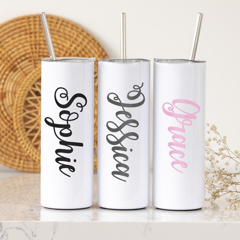 May include: Three white stainless steel tumblers with straws, each personalized with a different name: "Sophie", "Jessica", and "Grace".