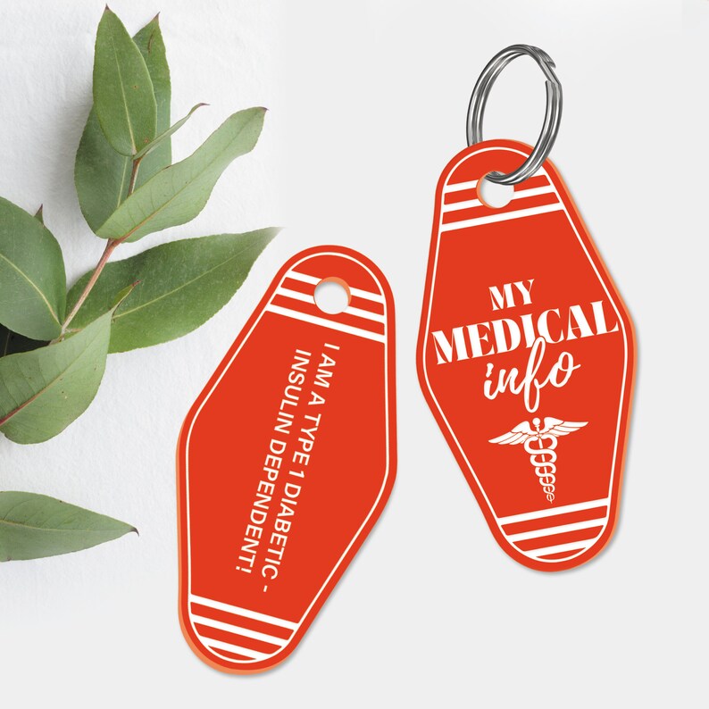 May include: Two red motel key tag style keychains with white text. One keychain says "My Medical Info" with a caduceus symbol. The other keychain says "I am a type 1 diabetic - insulin dependent!"