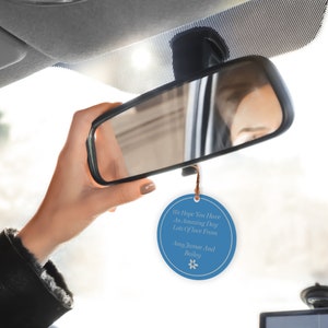 May include: Blue round car air freshener with the text "We Hope You Have An Amazing Day Lots Of Love From Amy Jamee And Bailey" and a small white flower graphic.