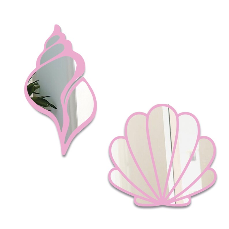May include: Two pink acrylic shell-shaped mirrors. The larger mirror is a scallop shell shape. The smaller mirror is a conch shell shape.