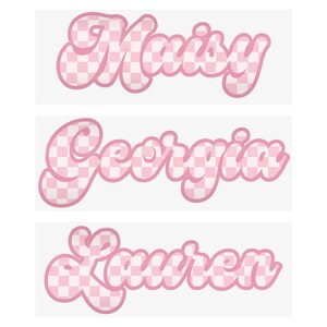 May include: Three names, "Maisey", "Georgia", and "Lauren", are displayed in a playful, bubble-style font. Each name is outlined in a soft pink, with a checkered pattern in the same pink and white color scheme filling the letters. The names are stacked vertically.
