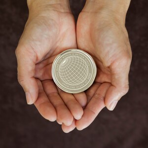 May include: A silver coin with the words "You make the world a better place from the class of 2024" and a globe design.