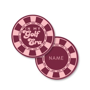 May include: Two pink and maroon round coasters with a white border and a checkered pattern. One coaster says "In My Golf Era" in pink text. The other coaster has a blank space for a name.