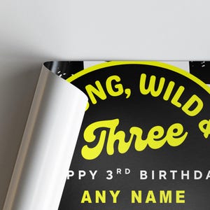 May include: A black and yellow birthday poster with the words "Young, Wild & Three" in yellow. The poster also includes the text "Happy 3rd Birthday" and "Any Name" in white.