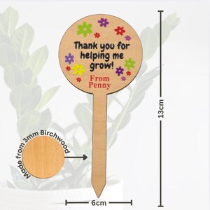 May include: A wooden plant marker, 13cm tall and 6cm wide, with the text "Thank you for helping me grow! From Penny" and colorful flower accents. Made from 3mm birchwood.
