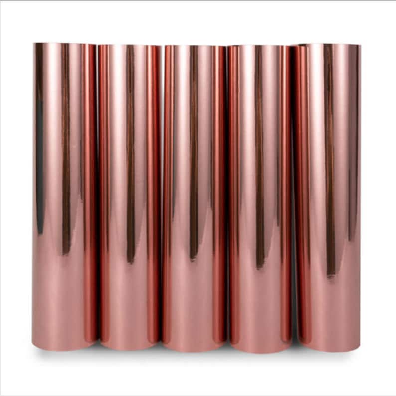 May include: Six rolls of rose gold metallic vinyl, each roll is approximately 12 inches wide.