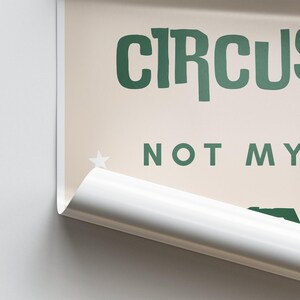May include: A beige poster with green text that reads "CIRCUS NOT MY...