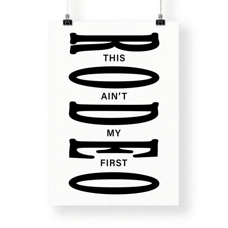 May include: Black and white graphic print with the text "This ain't my first rodeo" in a stylized font.