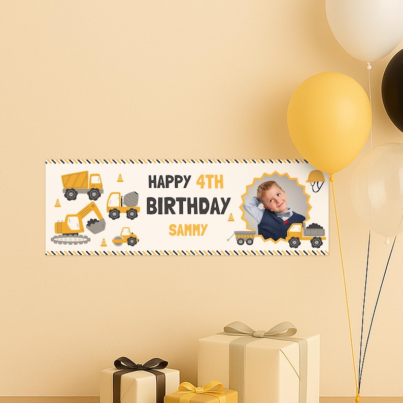 May include: A personalized birthday banner with the text "HAPPY 4TH BIRTHDAY SAMMY" and construction vehicle illustrations. The banner includes a photo of a young boy and is decorated with yellow and black accents. Balloons and wrapped gifts are in the background.