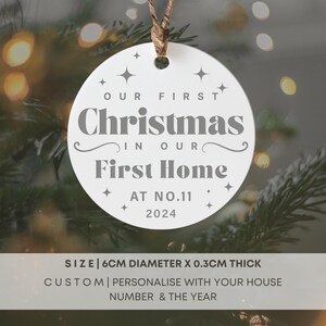 May include: White ceramic Christmas ornament with the text "Our First Christmas in Our First Home at No. 11 2024".