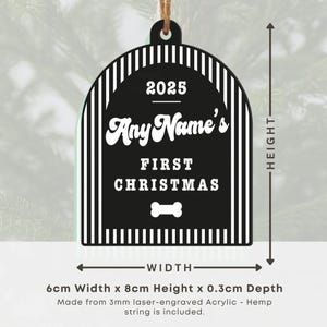 May include: Black and white acrylic Christmas ornament with a bone shape and the text "Any Name's First Christmas" and the year 2025. The ornament is 6cm wide, 8cm high, and 0.3cm deep, with a hemp string for hanging.