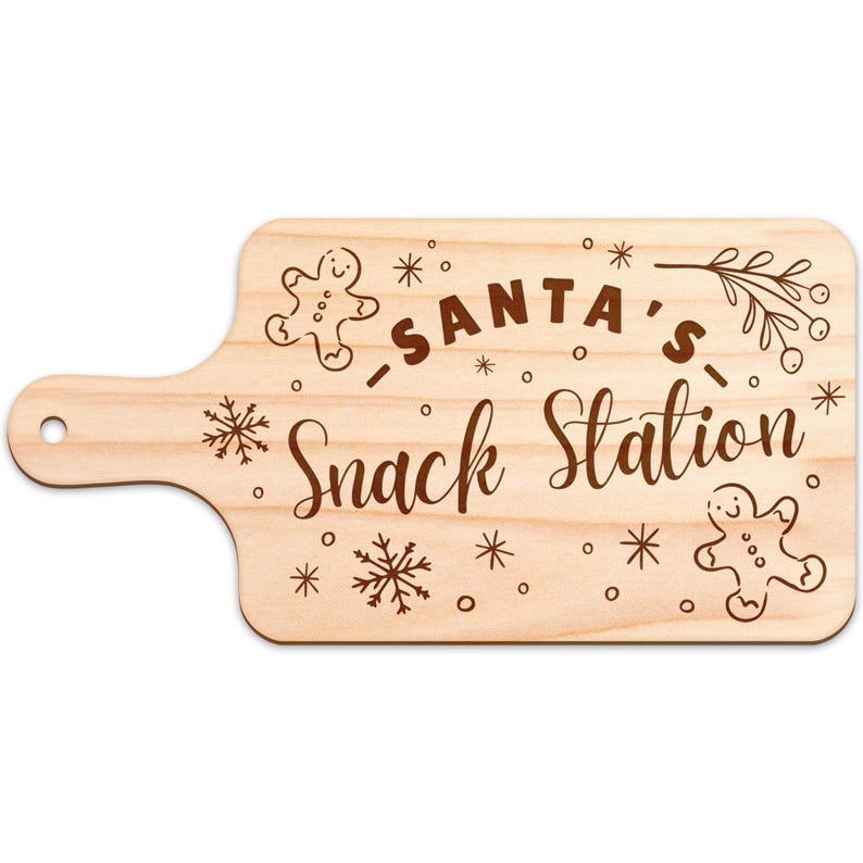 May include: Wooden cutting board with a handle, engraved with "SANTA'S Snack Station" in a decorative font. The design includes gingerbread men, snowflakes, and sprigs, perfect for holiday entertaining.