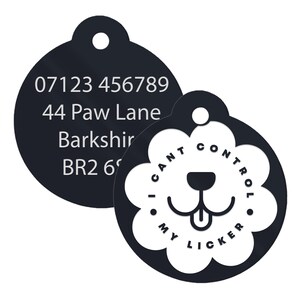 May include: Black and white dog tag with a phone number, address, and the text "I can't control my licker" on a white background.
