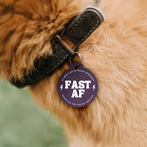 May include: Purple dog tag with white text that reads "My mum is out of breath somewhere FAST AF Please call her. She may need help."