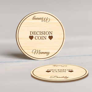 May include: Wooden decision coin with the text "DECISION COIN" and two heart symbols. The coin has the word "Mummy" engraved on the top and bottom. A second coin with the word "Daddy" is also visible.