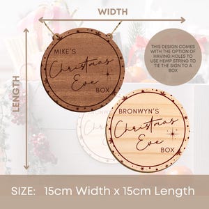 May include: Two round wooden Christmas Eve box signs with red text and snowflakes. The signs are 15 inches wide and 15 inches long. The text on the signs reads "Mike's Christmas Eve Box" and "Bronwyn's Christmas Eve Box".