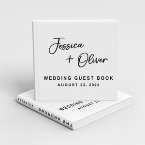 May include: White wedding guest book with the text "Jessica + Oliver" and "Wedding Guest Book August 23, 2023".