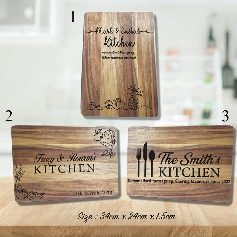 May include: Three wooden cutting boards with personalized text and kitchen-themed designs. The first board says "Mark & Sasha's Kitchen" with a pineapple and other fruit illustrations. The second board says "Tracy & Rowan's KITCHEN" with a tomato, pepper, and other vegetable illustrations. The third board says "The Smith's KITCHEN" with a fork, knife, and spoon illustration. All boards are 34 cm x 24 cm x 1.5 cm.