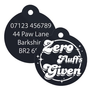 May include: Black and white round dog tag with a phone number, address, and the text "Zero Fluffs Given" in a retro font.