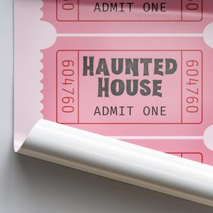 May include: Pink "Haunted House" admission tickets with the text "ADMIT ONE" and the number "604760". The tickets have a perforated edge and are partially rolled up, revealing a white backing.
