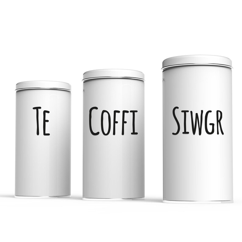 May include: Three white metal canisters with black lettering. The canisters are labeled "TE", "COFFI", and "SIWGR".