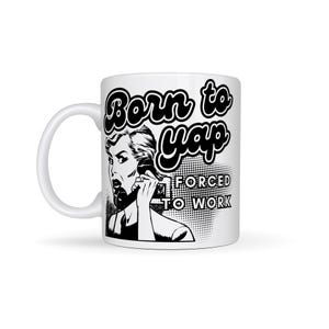 May include: White ceramic coffee mug with a black and white illustration of a woman on the phone. The text "Born to yap forced to work" is printed on the mug.