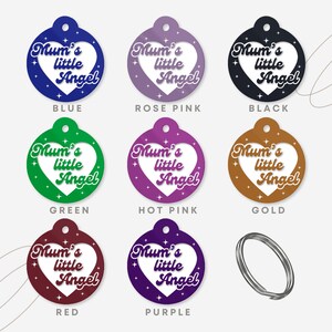 May include: Nine different colored round pet tags with a white heart shape in the center. The heart has the text "Mum's little Angel" in a retro font. The colors are blue, rose pink, black, green, hot pink, gold, red, purple, and silver.