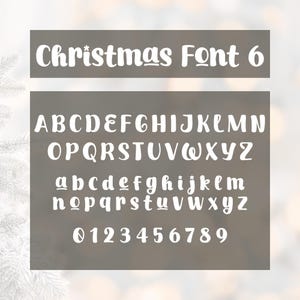 May include: A white Christmas Font 6, showcasing uppercase and lowercase letters, along with numbers 0-9. The font is displayed on a gray background, perfect for holiday-themed designs and crafts.