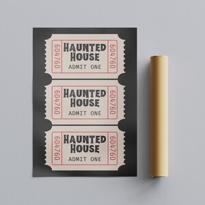 May include: Three vintage-style "Haunted House" tickets with the text "Admit One" and a six-digit number. The tickets are cream-colored with red borders and text, set against a dark gray background. A rolled-up poster is to the right.