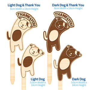 May include: Two wooden dog thank you signs. The sign on the left has a light brown dog with brown spots and the text "THANK YOU". The sign on the right has a dark brown dog with white spots and the text "THANK YOU". Both signs are 6 cm wide and 14 cm high.