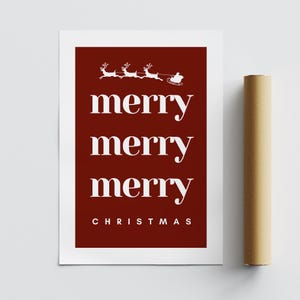 May include: A Christmas-themed print with a deep red background and white text. The words "merry merry merry" are stacked vertically, with "CHRISTMAS" at the bottom. Above the text is a graphic of Santa's sleigh being pulled by reindeer.