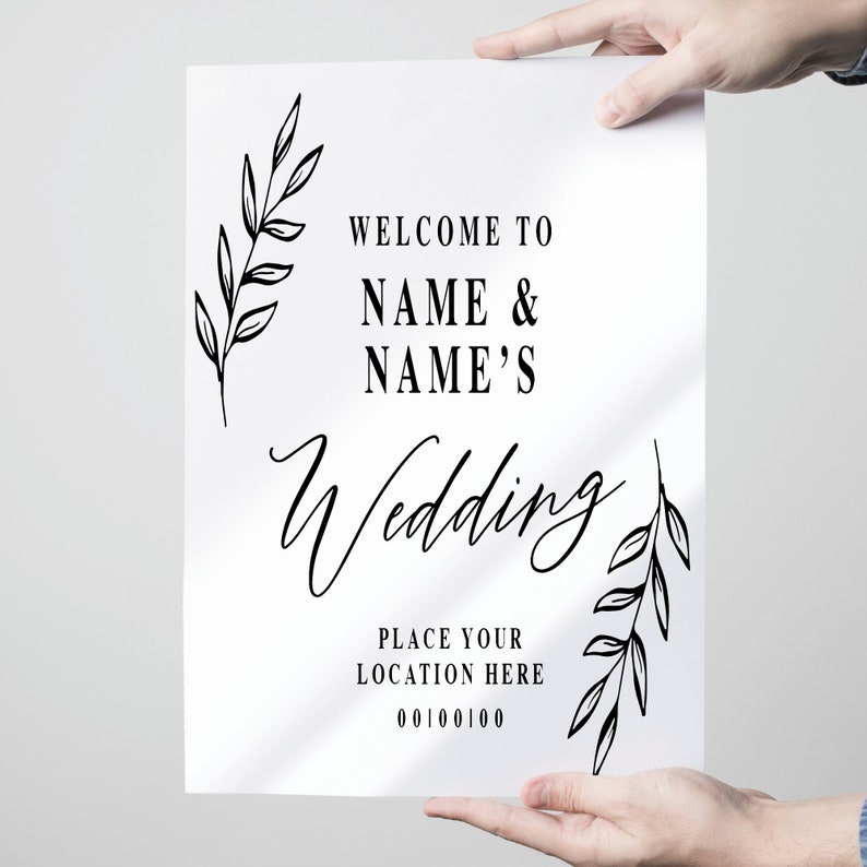 Pode incluir: Um cartaz de casamento branco com texto preto e detalhes florais. O cartaz diz "Bem-vindos ao casamento de NAME & NAME'S. Coloque sua localiza&ccedil;&atilde;o aqui 00100100".