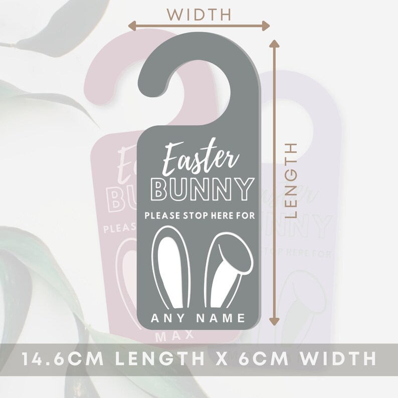 May include: A gray door hanger with a white bunny ear design and the text "Easter Bunny Please Stop Here For [Name]" in white. The door hanger measures 14.6 cm in length and 6 cm in width.