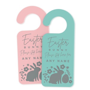 May include: Two Easter bunny door hangers, one pink and one teal. Each features a bunny silhouette, flowers, and the text "Easter Bunny Please stop here for [Name]"