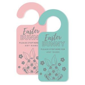 May include: Two Easter-themed door hangers. One is pink, the other is teal. Each features the text "Easter BUNNY PLEASE STOP HERE FOR ANY NAME" in gray, along with a bunny and egg design and floral accents.