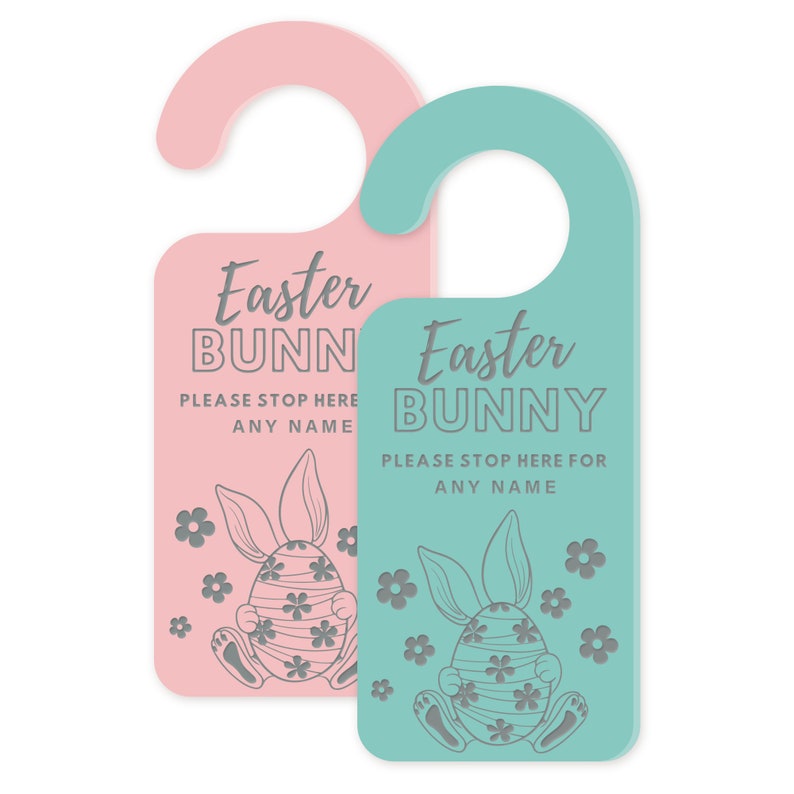 May include: Two Easter-themed door hangers. One is pink, the other is teal. Each features the text "Easter BUNNY PLEASE STOP HERE FOR ANY NAME" in gray, along with a bunny and egg design and floral accents.