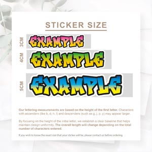 Op de afbeelding: Afbeelding toont drie stickers met het woord "EXAMPLE" in een graffitistijl. De stickers zijn in verschillende maten, met hoogtes van 3 cm, 4 cm en 5 cm. De tekst "STICKER SIZE" staat bovenaan. De stickers hebben een zwarte omtrek en een kleurverloopvulling.